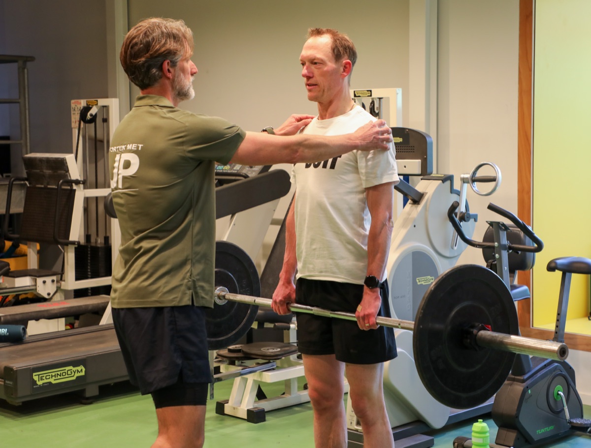 Jan-Peter corrigeert de houding van een sporter